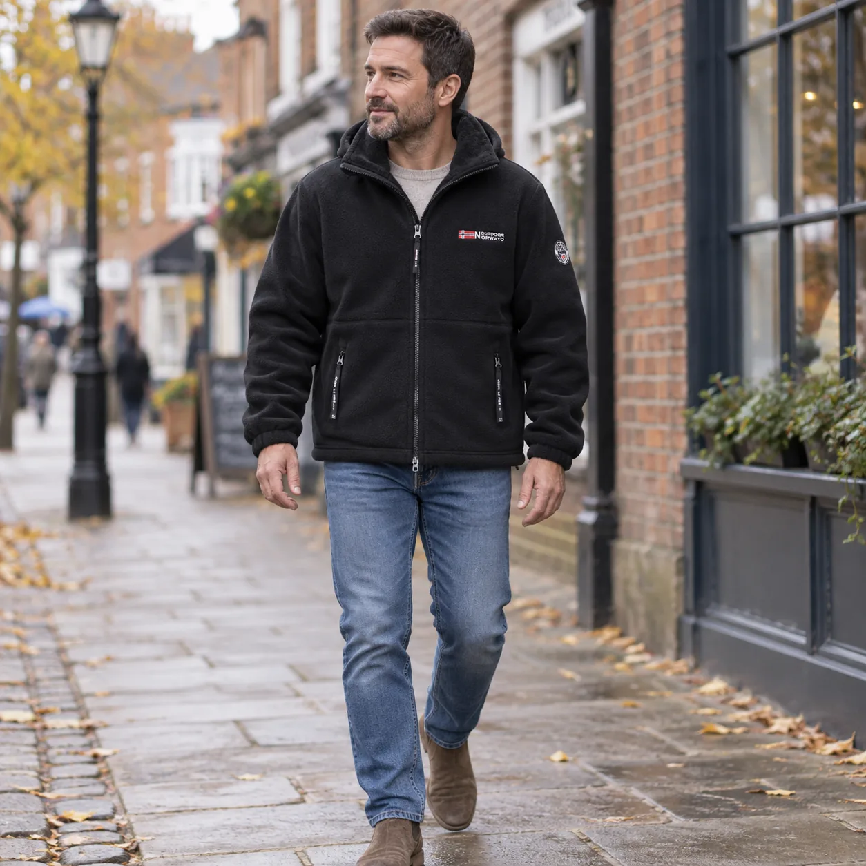 Man wearing the black Norway jacket while walking through town